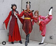 three women dressed in costumes posing for the camera