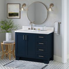 a bathroom with a sink, mirror and rug