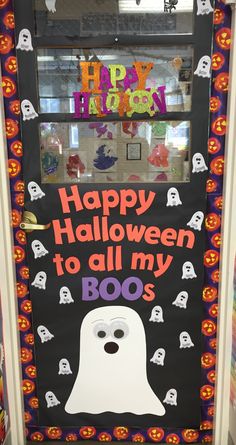 a door decorated for halloween with ghost faces and boo's written on the front