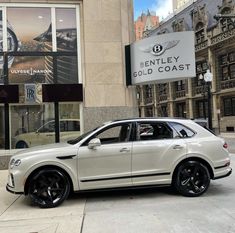 a white car parked in front of a building