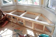 the inside of a house being built with wooden framing and window frames on the floor