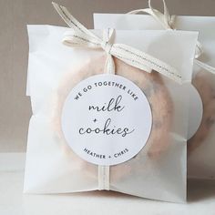 two donuts wrapped in white paper and tied up with a tag that says we do together like milk and cookies