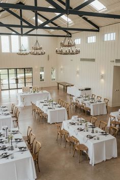 Farm House tables with Linens Metal Building Event Space, Rustic Event Center, Barndominium Event Space, Venue Kitchen, Farm House Tables, Barn Event Space, Rustic Outdoor Bar