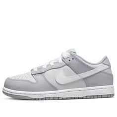 The Nike Dunk Low Two Toned Grey is a classic sportswear staple. Its iconic toebox perforations are just one part of its appeal, with eye catching details like white shoe laces and splashes of grey and blue in the tongue making it stand out even further. On top of the classic black sole, you'll find a white midsole and striking patches of grey leather on a white base. The design is complete with the famous swoosh made from white leather. If you’re looking for classic street style with an edge, these Nike Dunk Low shoes are perfect for you. (SNKR/Skate/Light/Low Top) Grey Low Dunks, $50 Shoes, Grey Nike Dunks, Nike Shoes Low Top, Gray Nikes, Basic Nike Shoes, Cute Shoes For Back To School 2024, Shoes To Get For Your Birthday, Nike Dunks Grey