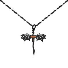 a black and orange dragon pendant on a chain