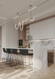 a kitchen with marble counter tops and barstools in the center, surrounded by wooden flooring