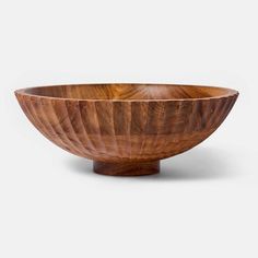 a wooden bowl sitting on top of a table