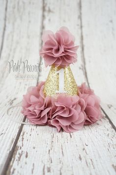 a pink and gold birthday hat with flowers