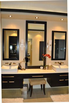 a large bathroom with two sinks and mirrors