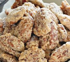 a white plate filled with cookies covered in powdered sugar on top of a table