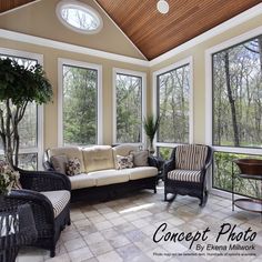 a sun room with two couches and chairs