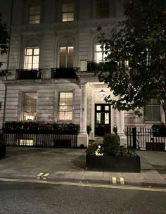 a large white building with many windows at night