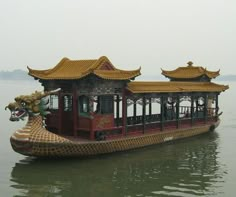 a dragon boat floating on top of a body of water