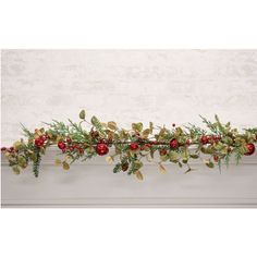 a christmas garland with red berries and greenery