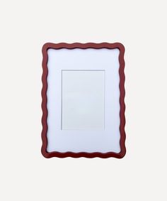 a red and white frame with a square in the middle on a white wall background