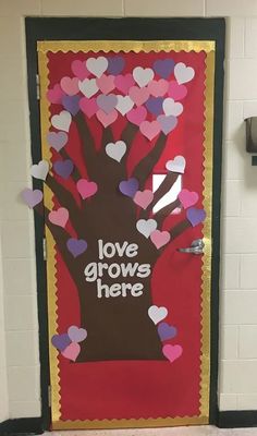 a door decorated with hearts and the words love grows here