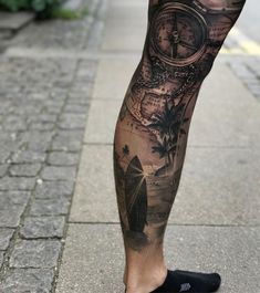 a man's leg with a clock and surfboard tattoo on it, while he is walking down the street