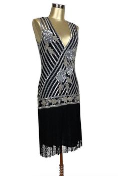 Exciting and romantic - our Artist Gown is the perfect dancing dress! A new take on the iconic fringe dresses of the 1920's, this gown will make you the star attraction at every event. Features include a handbeaded Deco rose design, deep vneck, and long silky fringe. So popular, the black and silver version of this gown was featured in the Academy Award winning film, "The Artist". Sheer, so a slip is recommended. XS....bust 30-34", waist 26-30", hips 34-38", length 49" S....bust 32-36", waist 28 Cocktail Flapper Dress With Fringe, Gatsby Style Flapper Dress For Party Season, Black Art Deco Dress For Costume Party, Glamorous Black Beaded Fringe Flapper Dress, Art Deco Flapper Dress For Evening Parties, 1920s Evening Dresses With Beaded Fringe, 1920s Style Beaded Fringe Evening Dresses, 1920s Beaded Fringe Evening Dresses, Gatsby Style Flapper Dress For Gala Party Season