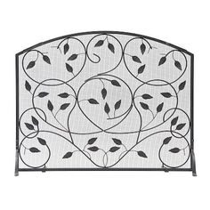 an iron fireplace screen with leaves on it