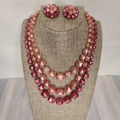 Vintage 1950s-1960s Three Strand Necklace And Clip On Earrings. Pyramid Studded Shaped In Shades Of Pink Pearl. Necklace Is 18" Inches In Length Including Extender. This Is A True Vintage Item. It Is Preowned And Not In New Or Unused Condition. Other Details: Please See Photos For All Details. All Items Come From A Smoke Free Home. Items Will Be Wrapped In White Tissue And Most Shipped In New Boxes, Their Original Box, Or Mailers But I Will Recycle When I Can. Packing Slips Will Not Be Included Retro Round Beads Jewelry For Party, Retro Round Bead Jewelry For Parties, Retro Beaded Jewelry For Party, Retro Beaded Evening Jewelry, Retro Beaded Jewelry For Evening, Retro Evening Jewelry With Matching Earrings, Retro Pink Jewelry For Formal Occasions, Retro Beaded Party Jewelry, Retro Matching Earrings For Evening Jewelry