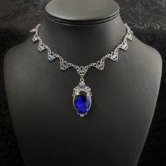 "This elegantly ornate necklace is made with antique silver tone centerpieces, featuring filigree and leaf details. Its mesmerizing design is accented with dazzling dark sapphire blue glass crystals with a large high quality faceted jewel hanging at its center.  Decorated portion is 8 1/2\" wide and 2 1/4\" tall in the very center.  Necklace length is adjustable with soldered stainless steel cable chain, lobster clasp and extender. If you would like a different length, please send us a message. If you don't see items with a color you want, feel free to ask about availability." Sapphire Vintage Necklace, Gothic Antique, Ornate Necklace, Medieval Necklace, Dark Sapphire, Victorian Wedding, Choker Pendant, Gothic Necklace, Stainless Steel Cable