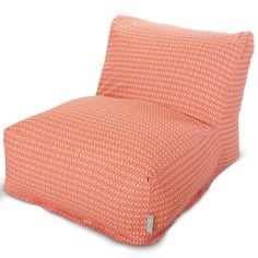 an orange and white patterned chair cushion with two pillows on the bottom one is folded up