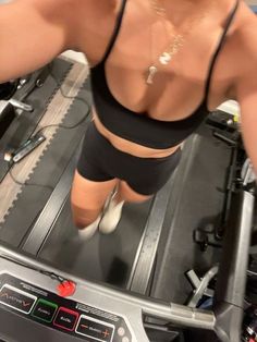 a woman is running on a treadmill