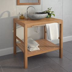 a bathroom with a sink, mirror and towel rack on the counter top in front of it