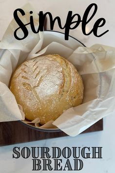 a loaf of sourdough bread in a basket with the words simple on it