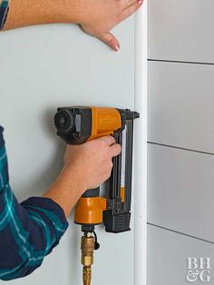 a man is drilling the wall with a drill