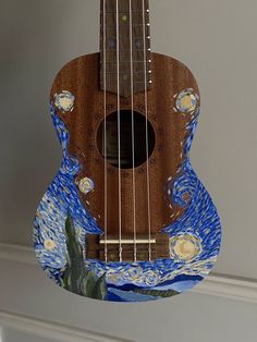 an acoustic guitar with the starry night painting on it's back and sides