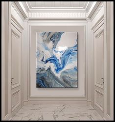 an abstract painting hangs in the middle of a room with white walls and marble flooring