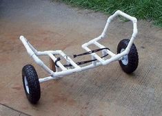 a white toy buggy sitting on top of a sidewalk