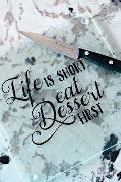 a knife that is sitting on top of a cutting board with words written on it