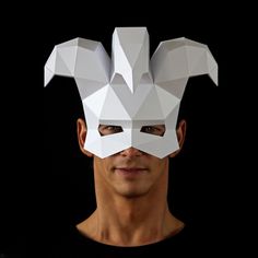 a man wearing a paper mask with an animal's head cut out from it