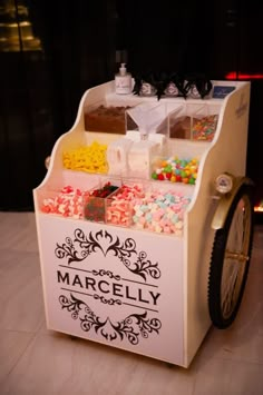 an ice cream cart with candy and candies on it