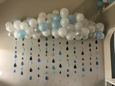 blue and white balloons hanging from the ceiling