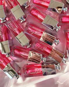 many pink lipsticks are laying on the ground