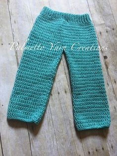 a close up of a child's leggings on a wooden floor with text that reads, free crochet pattern for baby pants