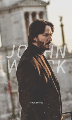 a man standing in front of a building with the words john wick on it