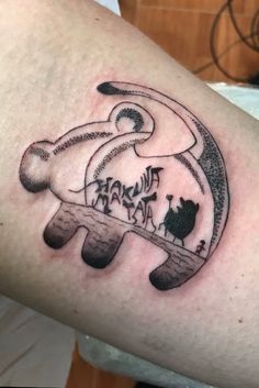 a person with a tattoo on their arm that has an elephant in the middle of it