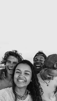 a group of young people standing next to each other on top of a hill smiling at the camera