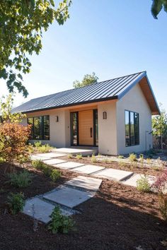 Modern ranch house with sleek design and clean landscaping. The charming rancher houses are the ultimate canvas for free-spirited living with an open floor plan and no stairs to trip over!