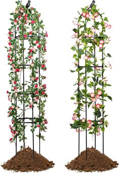 two tall metal planters with pink flowers and green leaves on them, one is filled with dirt