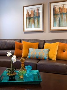 a living room filled with furniture and pictures on the wall above it's coffee table