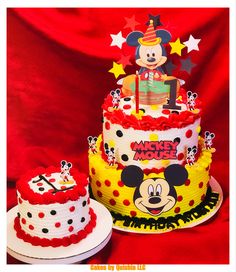 two mickey mouse birthday cakes on a red background