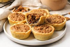 a white plate topped with mini pies on top of a table