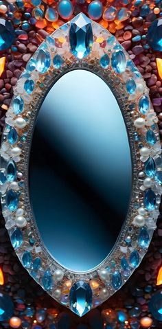 an oval mirror with many different colored stones around it