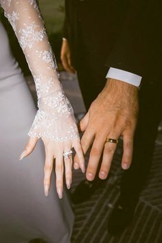 the bride and groom are holding hands together