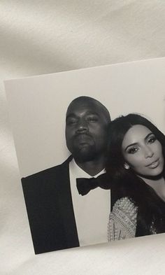 an old photo of two men and a woman in formal wear posing for the camera